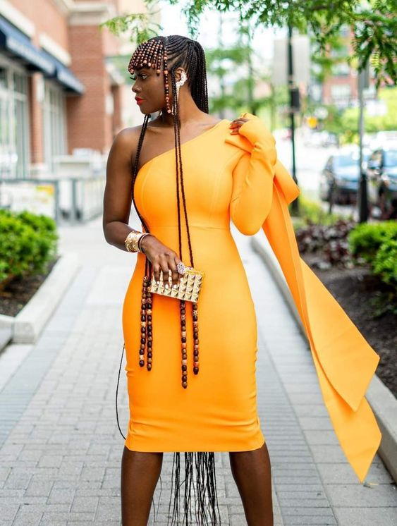 Woman in yellow dress with Fulani braids