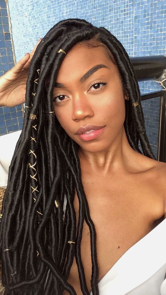 Beautiful woman wearing synthetic dreadlocks with extensions