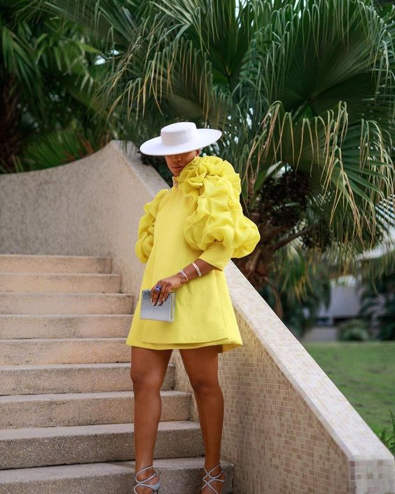 Woman in yellow dress with puffy sleeves