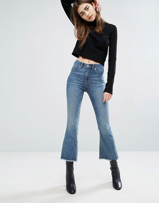 Cropped flared jeans model with ankle boots