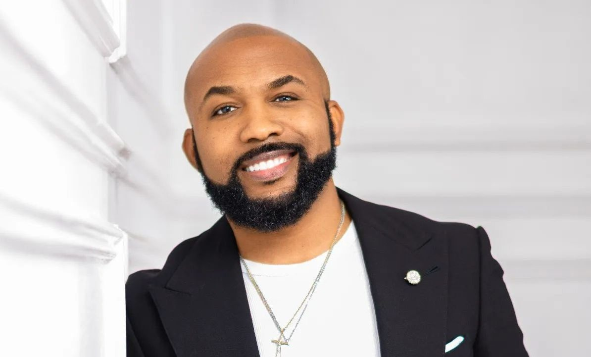 Banky W in a suit with a bald head