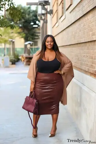 plus sized lady wearing leather pencil skirt with matching bags and shoes