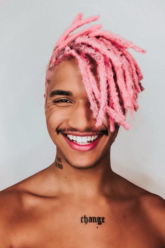 Smiling man rocking pink dreadlocks
