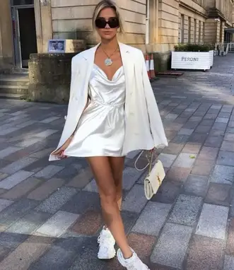 lady wearing little white dress with statement jewelry