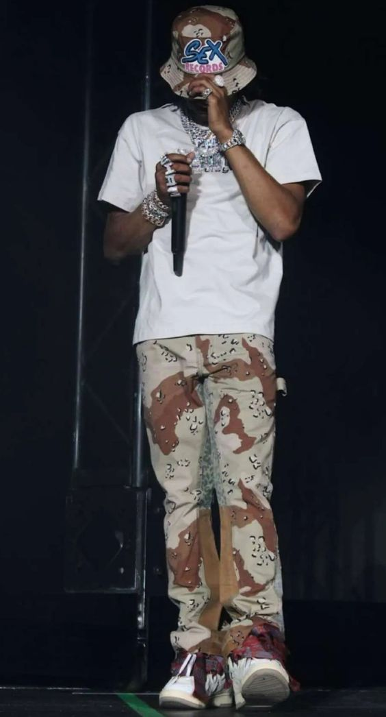 Rapper wearing a bucket hat on stage