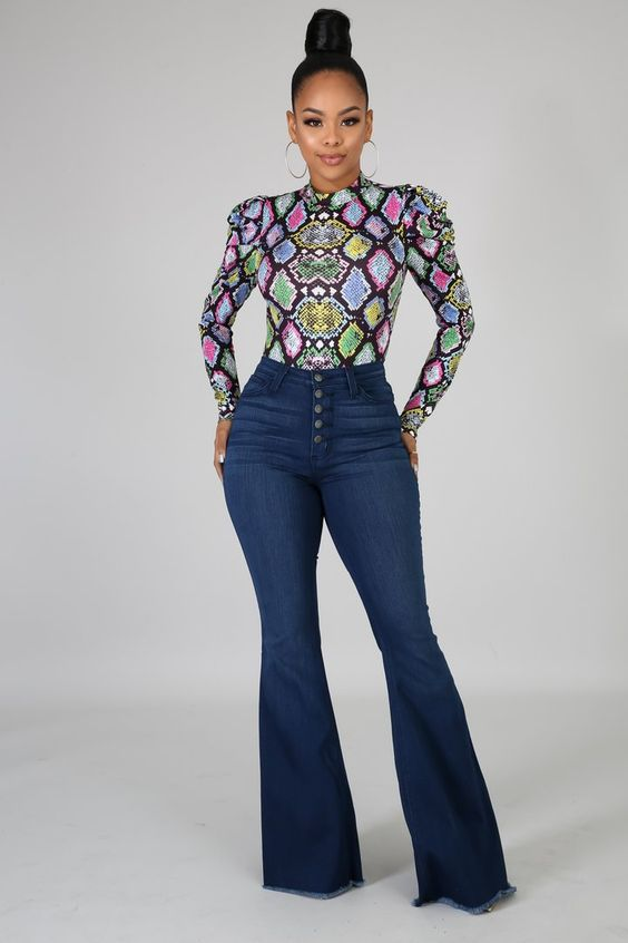 Woman in high-waisted flared jeans with multicolored turtleneck top