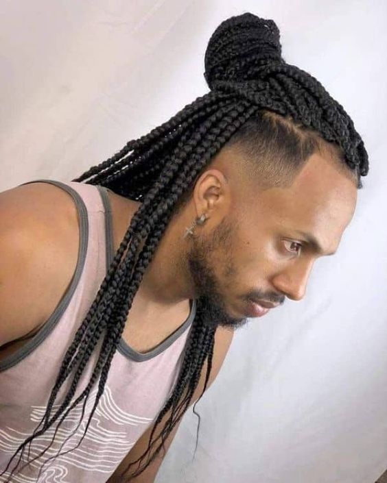 Cute guy rocking black long braid hairstyle for men