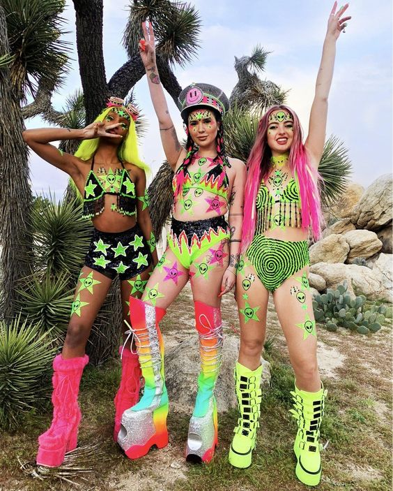 Three women in rave outfits at a rave party
