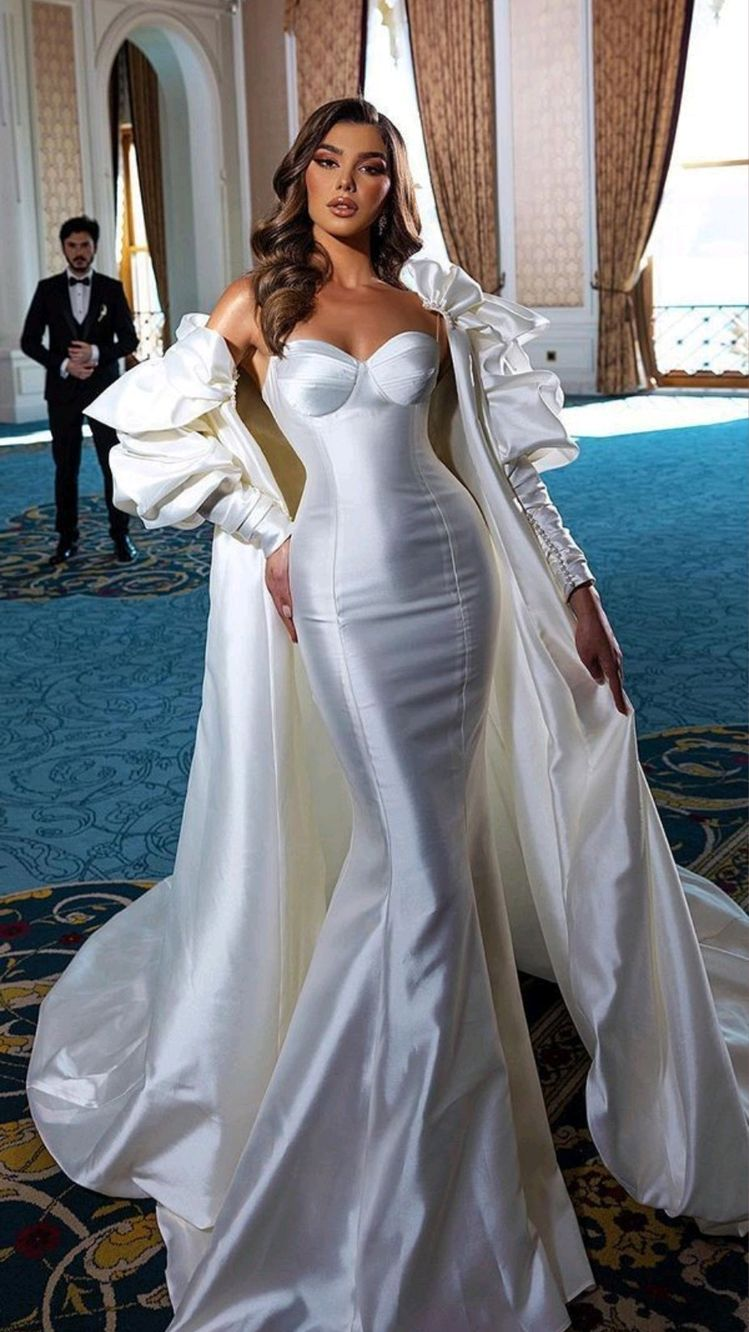 Woman wearing long white corset dress with cover-up