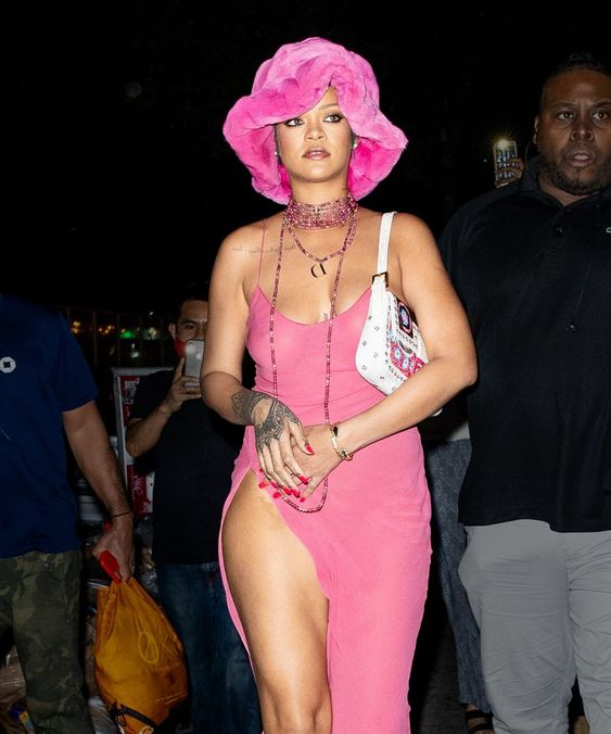 Rihanna in a matching dress with a pink fur bucket hat