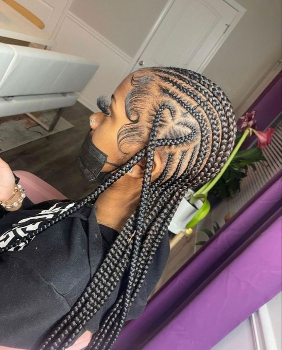 Side view of woman wearing braids with styled edges