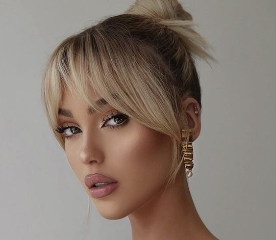 A woman wearing an updo with bangs