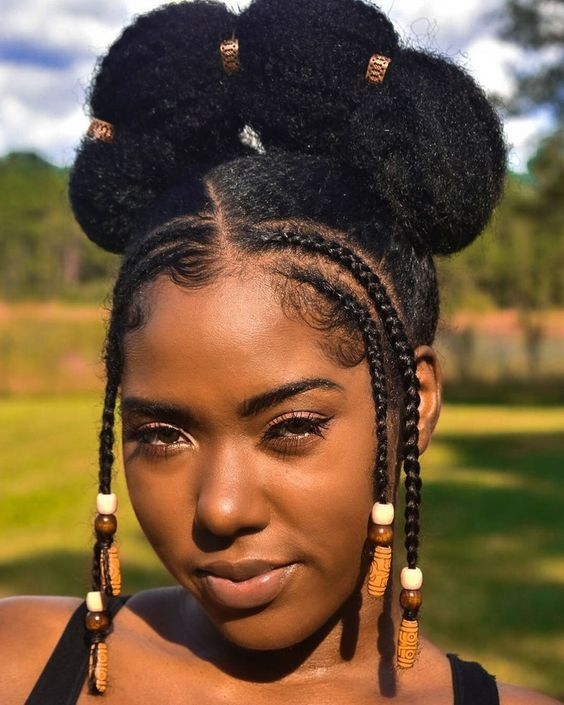 Woman wearing a natural bun with two braids on each side