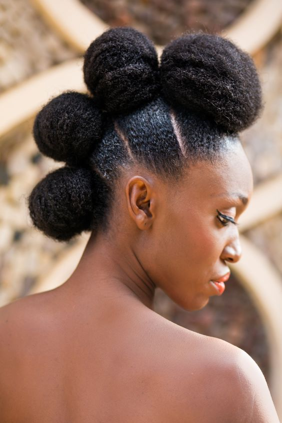 Woman wearing natural hair with four puffs