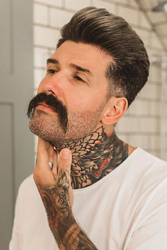 Man with neck tattoo discovering mustache