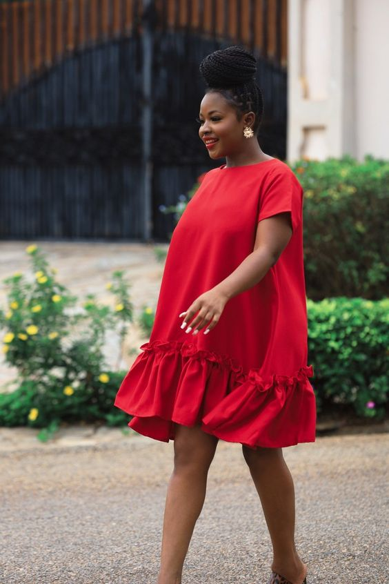 Woman in loose red dress with frills