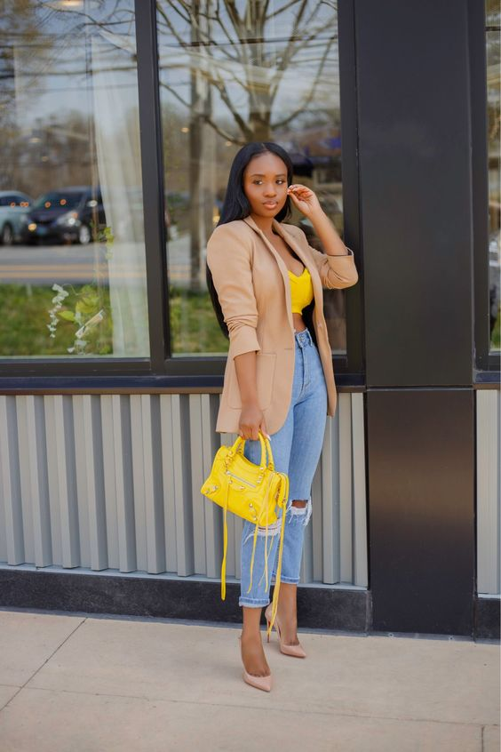 Woman wearing ripped jeans and jacket with heels