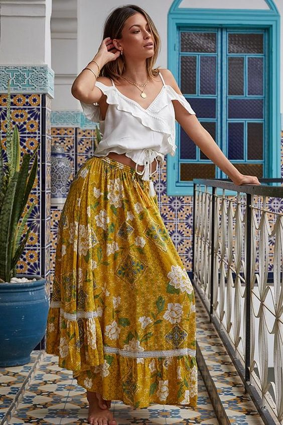 Woman wearing bohemian skirt and white top