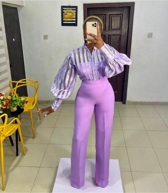Woman in lilac palazzo pants and lilac shirt