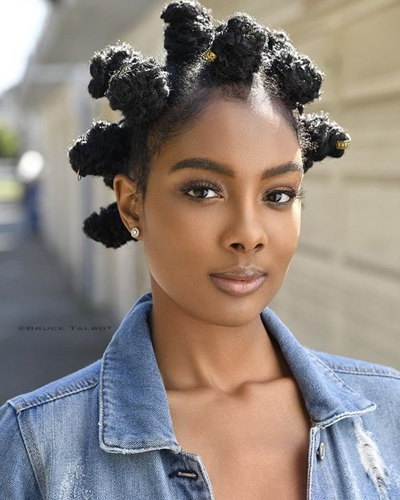 Woman wearing a bantu knot to style her natural short hair