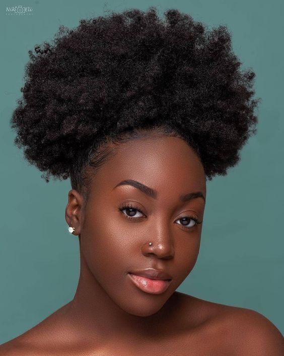 Gorgeous black woman wearing an afro puff for styling her natural short hair