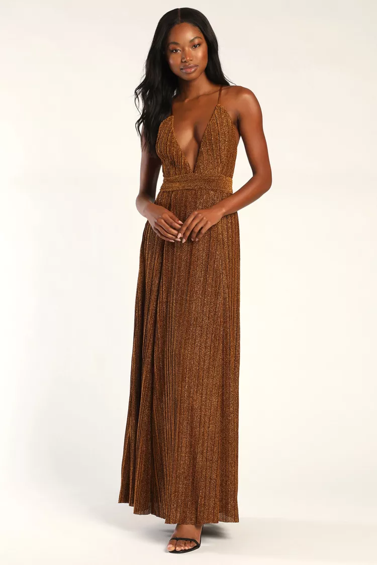 A woman in a brown maxi dress with a plunging chest