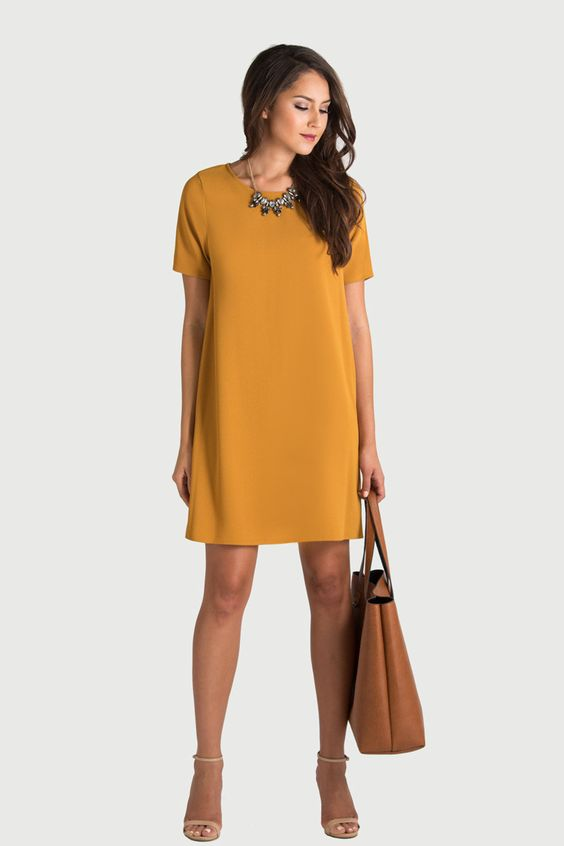 Woman in brownish-yellow dress with short sleeves