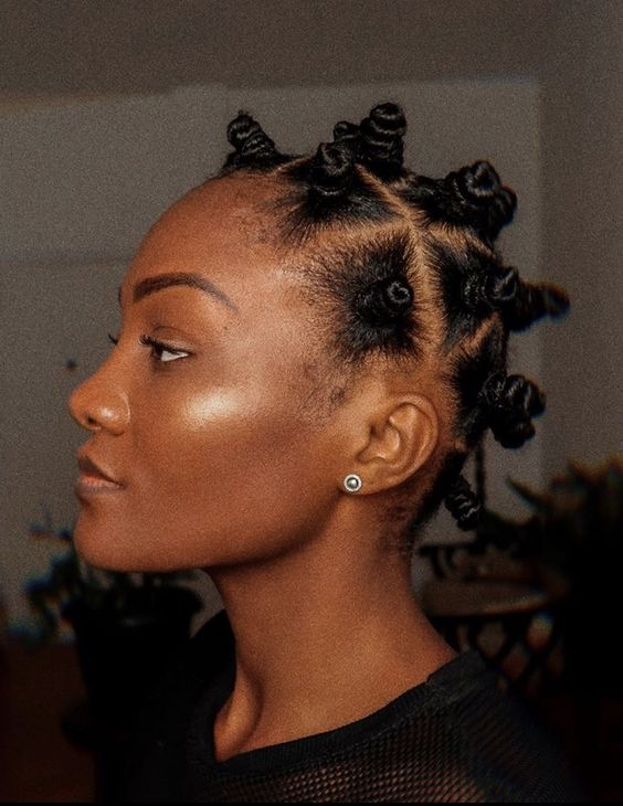 Cute woman wearing bantu knot for styling her natural short hair