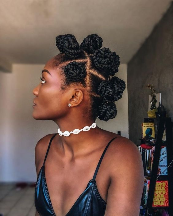 A woman wearing a bantu knot around her neck