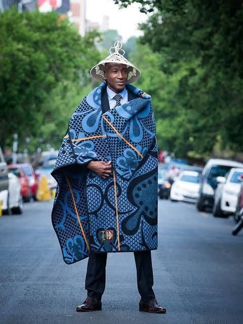 A man wearing traditional Sotho attire over a suit and tie