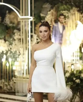 lady wearing little white dress at an event