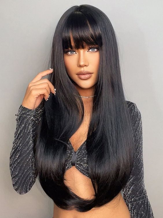Woman wearing bblack rown wig with bangs