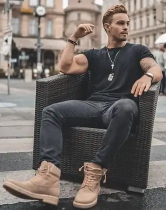 guy wearing a black T-shirt on black jeans with Timberland boots and chain