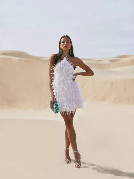 Woman wearing fur little white dress in the desert