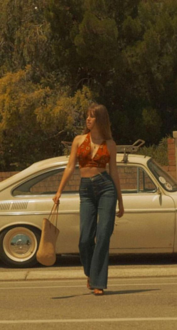 Woman wearing 70's flared jeans and crop top showing 70's women's fashion