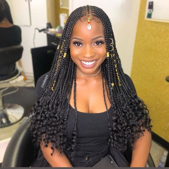 Smiling woman wearing curled Fulani braids
