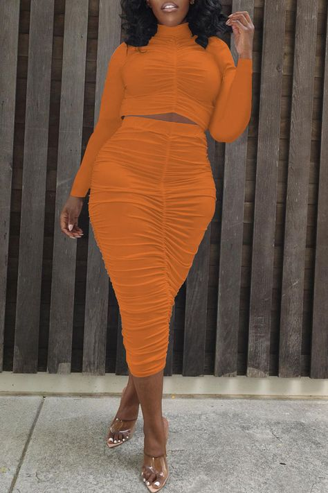 Woman wearing a pencil skirt and orange two-piece outfit