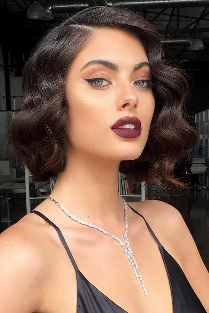 Brunette woman rocking beautiful necklace and short hair waves