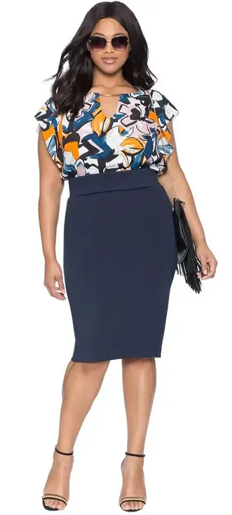 lady wearing flowery print top tucked in a pencil skirt