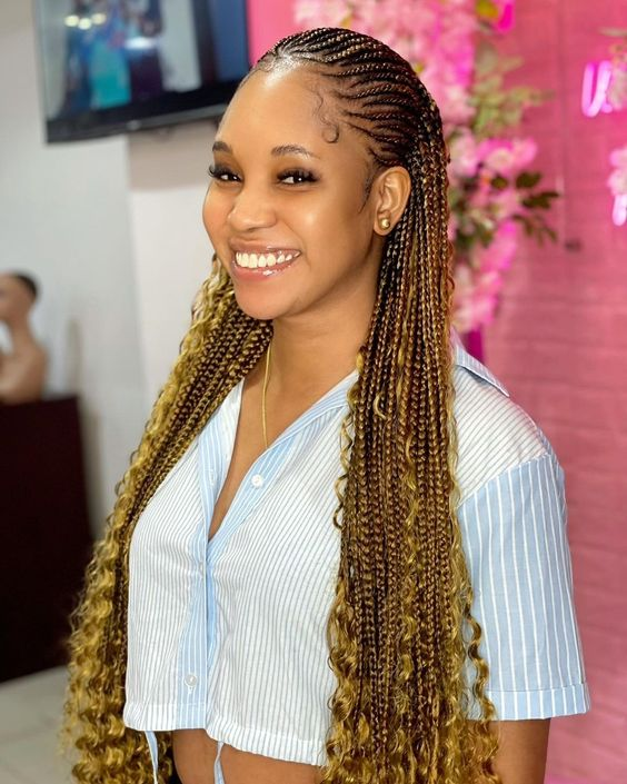 Smiling woman wearing gold and brown braid hairstyle