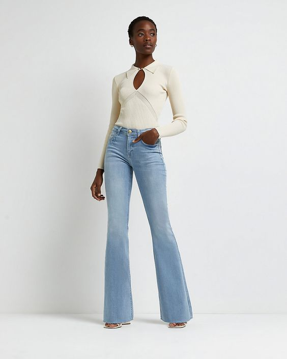 Woman in high-waisted flared jeans with a clean top