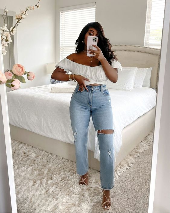 Woman taking a mirror image in white top and jeans