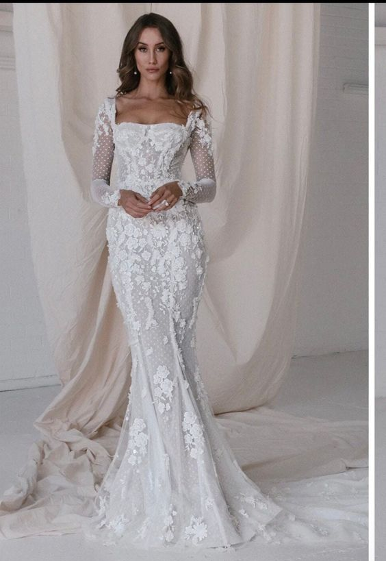 Woman in corset wedding dress with long sleeves
