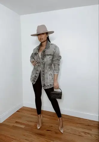 lady wearing jean jacket on leggings with hat and a handbag