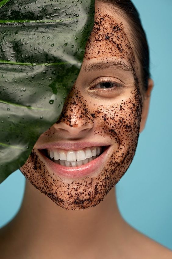 Smiling woman with exfoliating material on her face