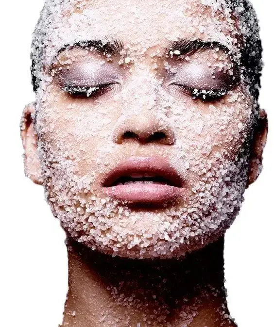 lady exfoliating her face