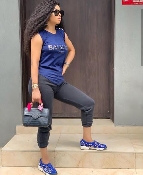 blue sneakers as styled by Toke Makinwa